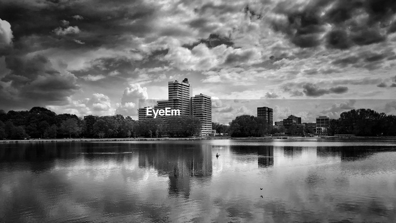 Reflection of buildings in lake against sky