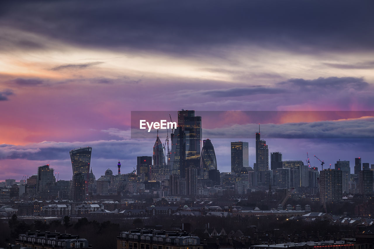 cityscape against sky at sunset