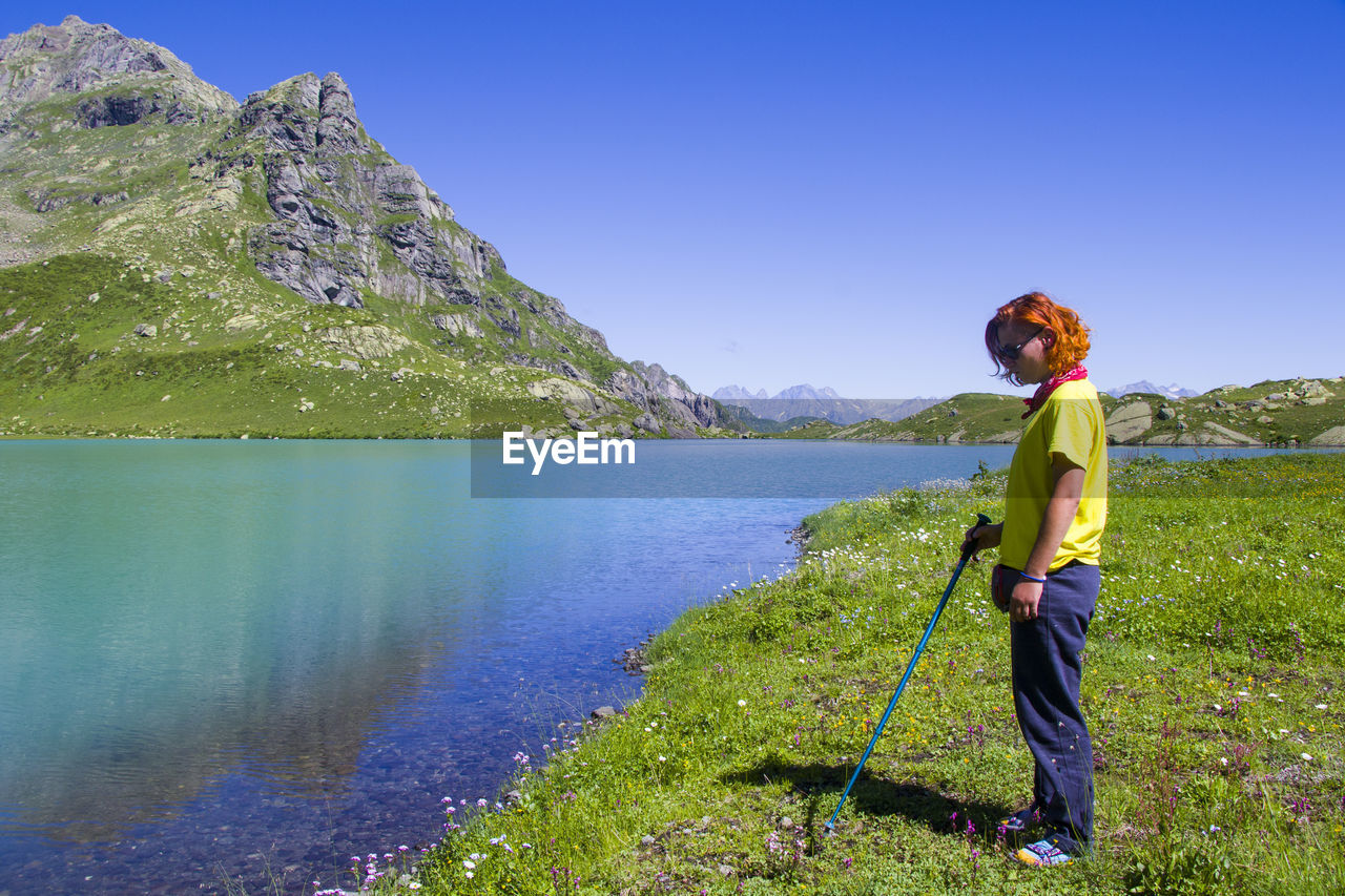 Hiker and backpacker in the mountain valley and field, trekking and hiking scene in svaneti, georgia