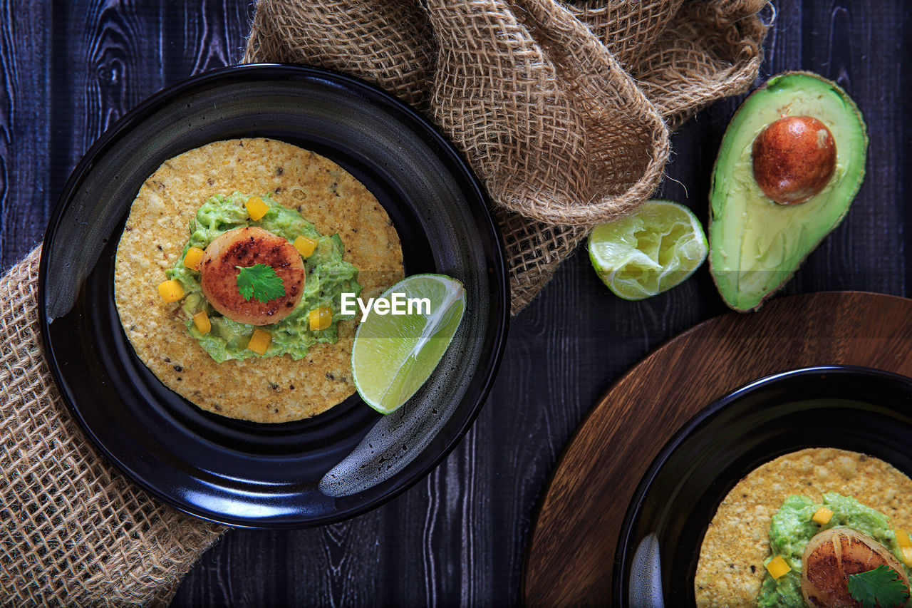 Close-up of scallop tostada and avocado on table