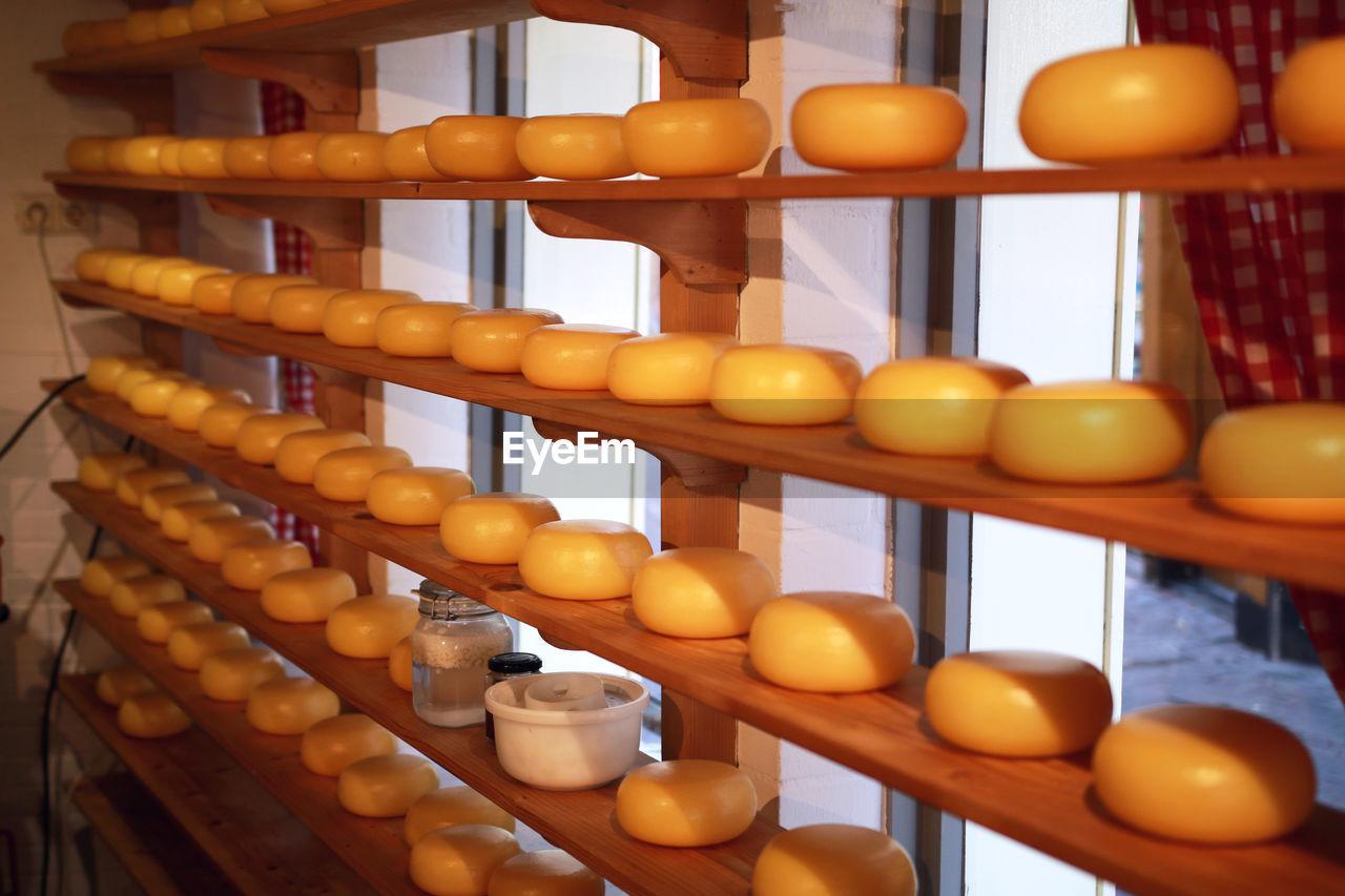 Close-up of cheese on shelves