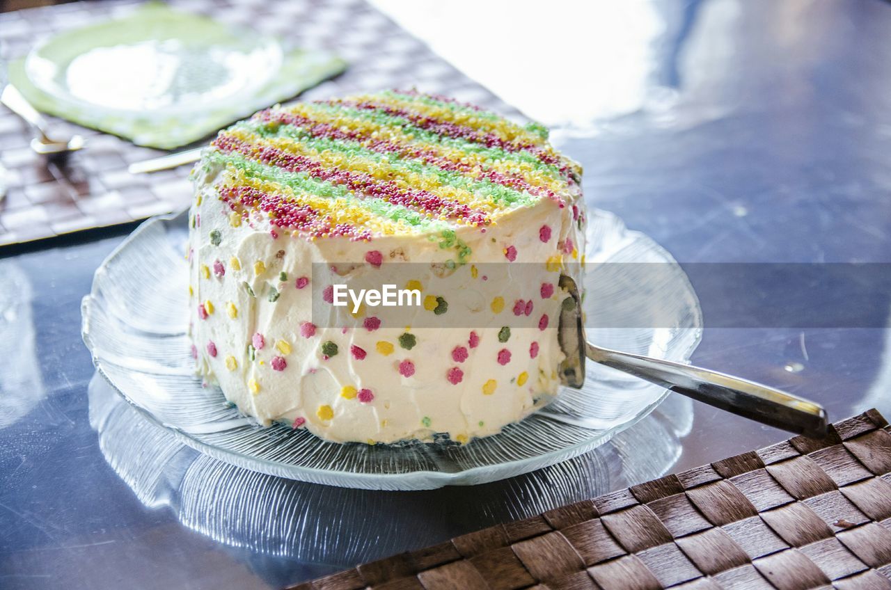 High angle view of multi colored cake served on table