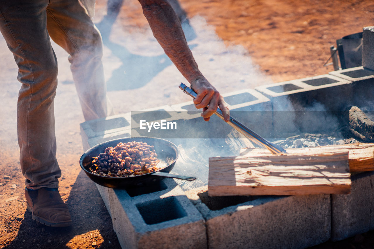 Low section of man preparing food