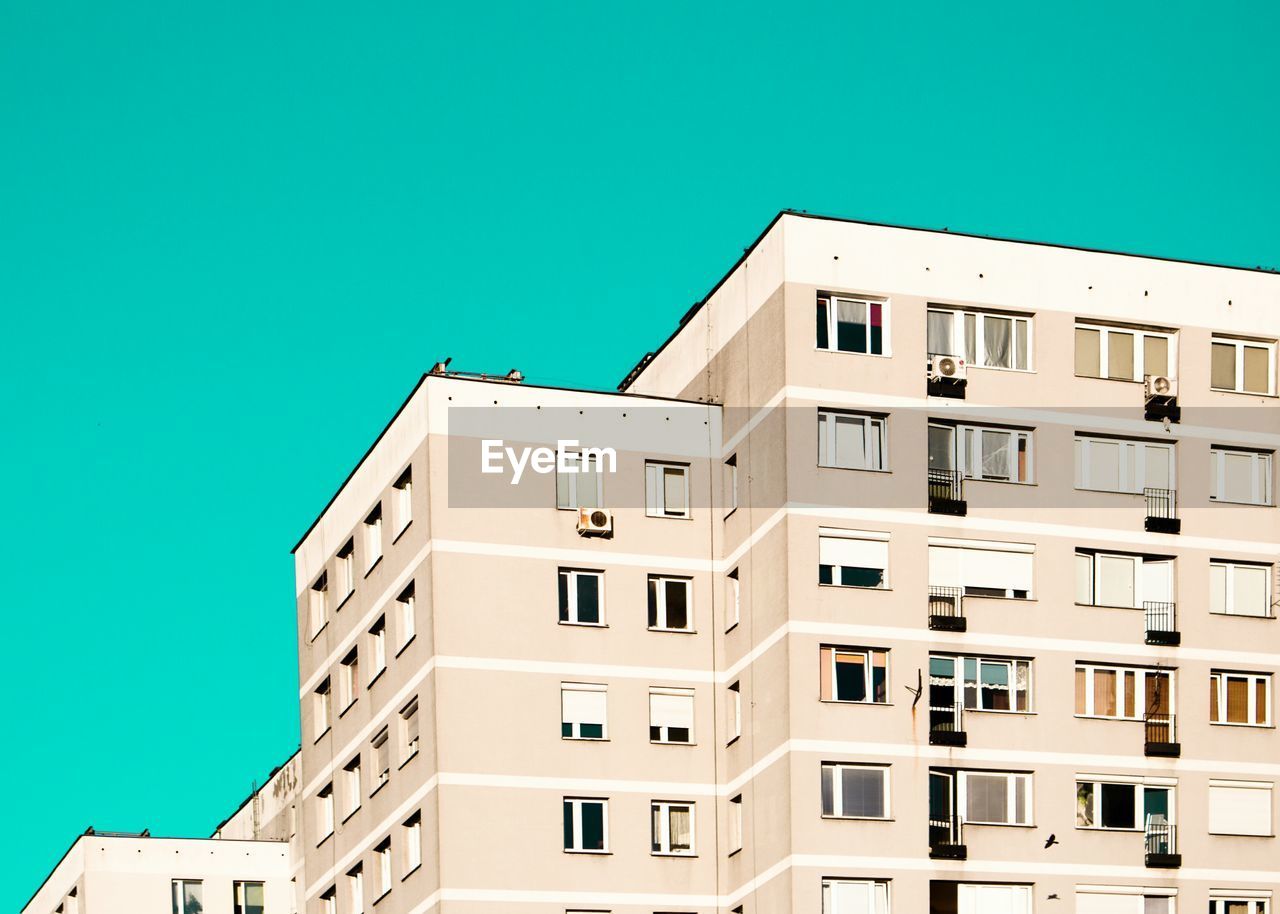 LOW ANGLE VIEW OF BUILDING AGAINST BLUE SKY