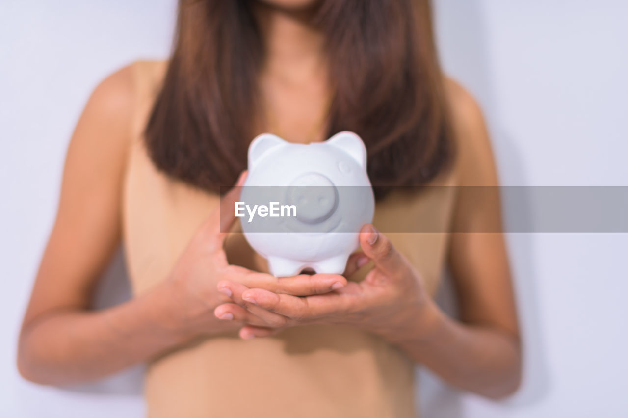 MIDSECTION OF WOMAN HOLDING HEART SHAPE WITH TEXT ON FACE