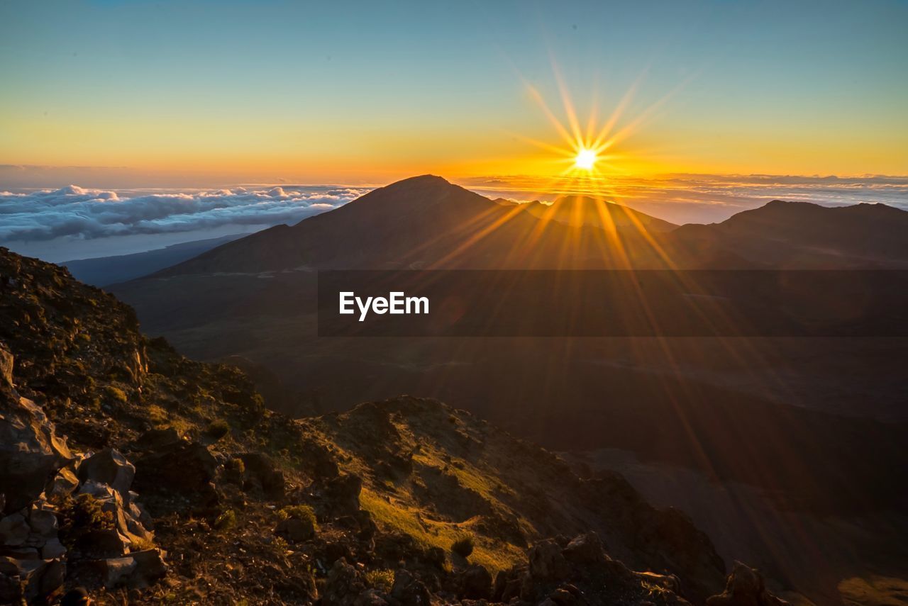 Scenic view of mountains against sky during sunset