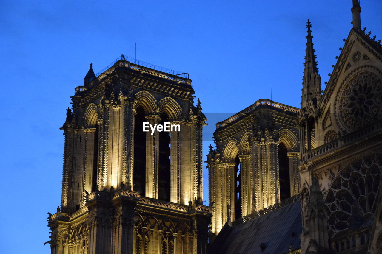 Low angle view of norte dame church against clear blue sky