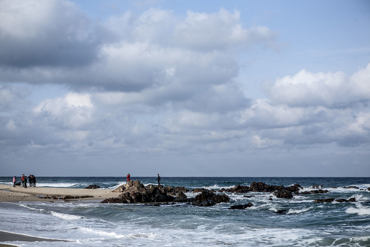 View of beach against cloudy sky