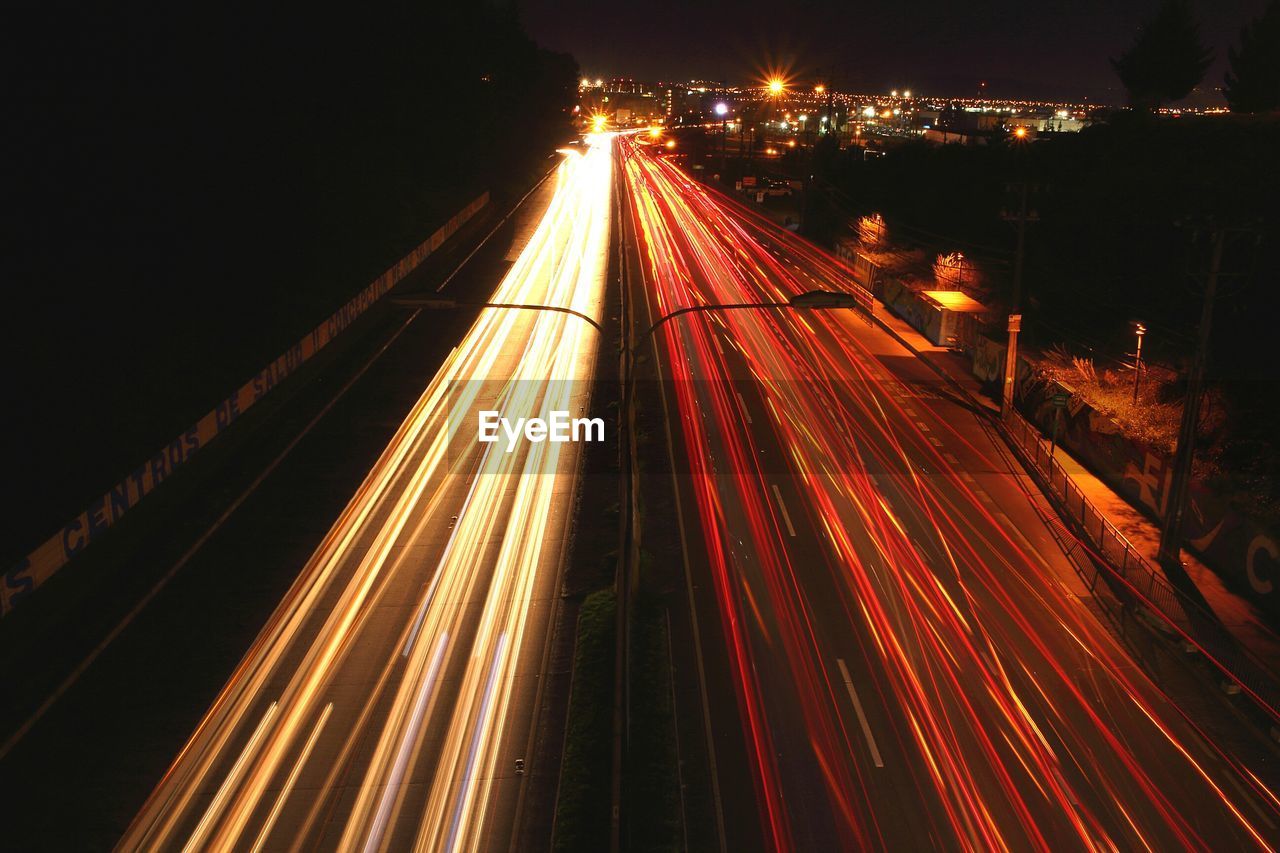 Streaks of lights of moving vehicles on road at night
