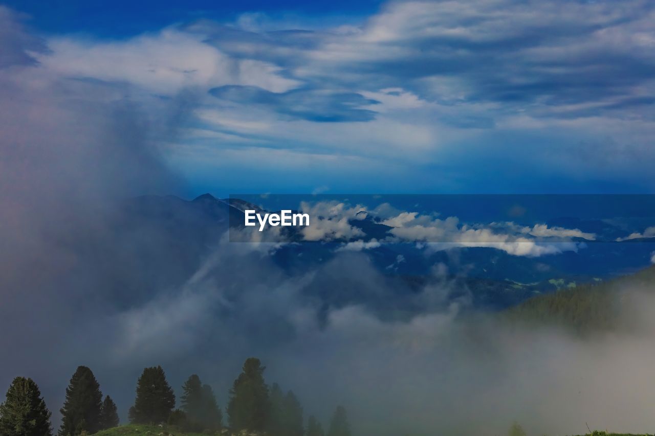 LOW ANGLE VIEW OF CLOUDS OVER MOUNTAIN