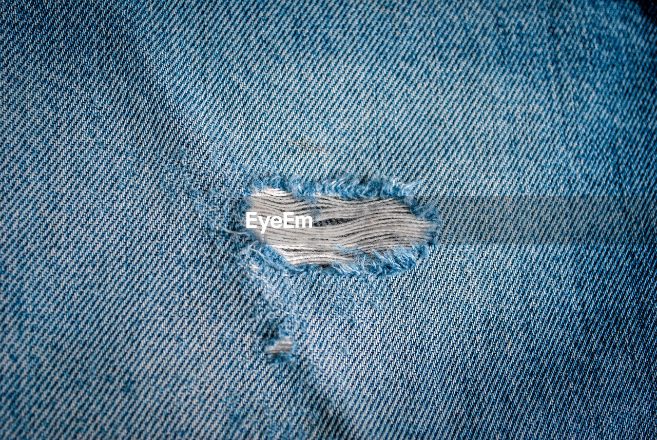 Close-up of hole in jeans