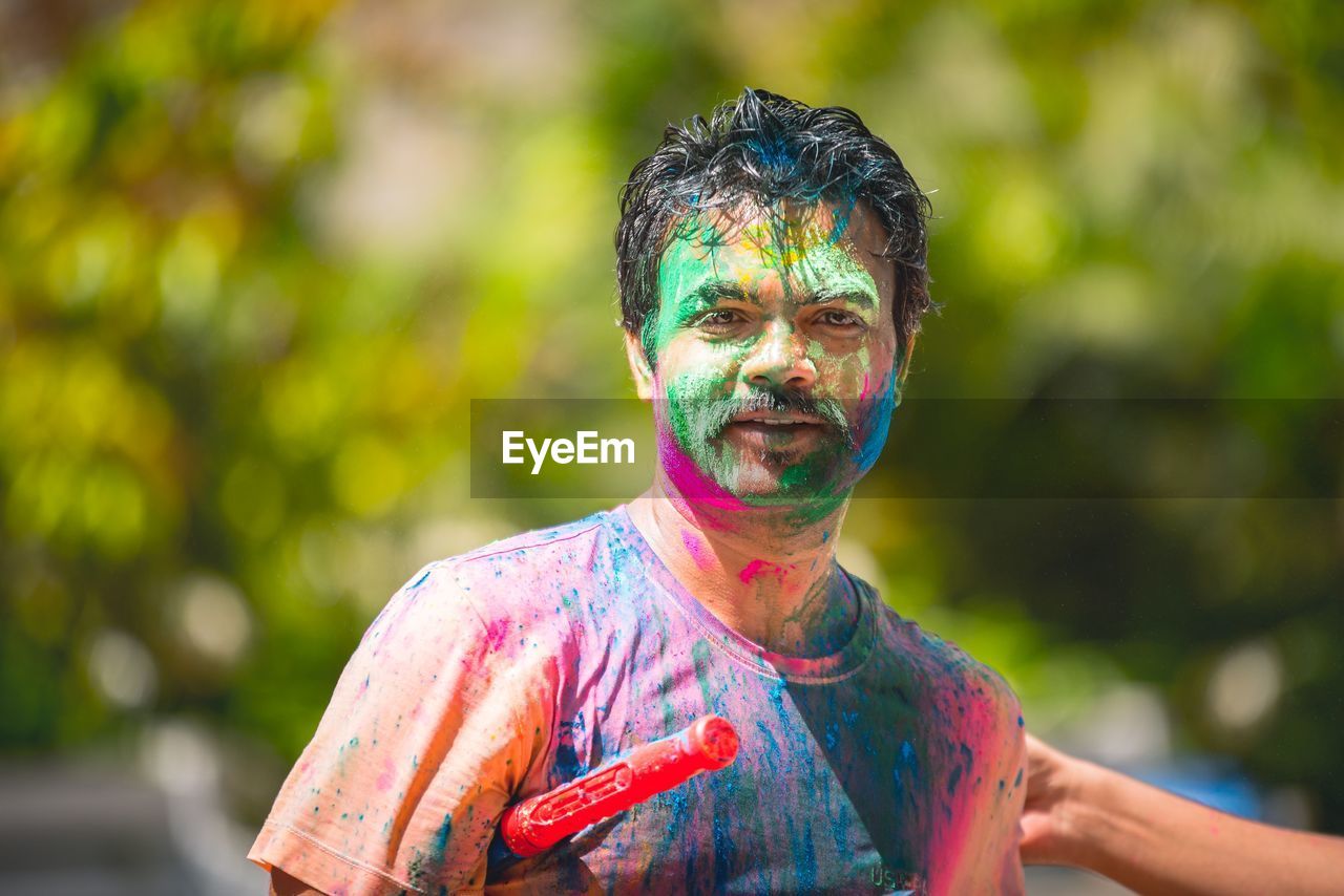 Portrait of man with face paint during holi