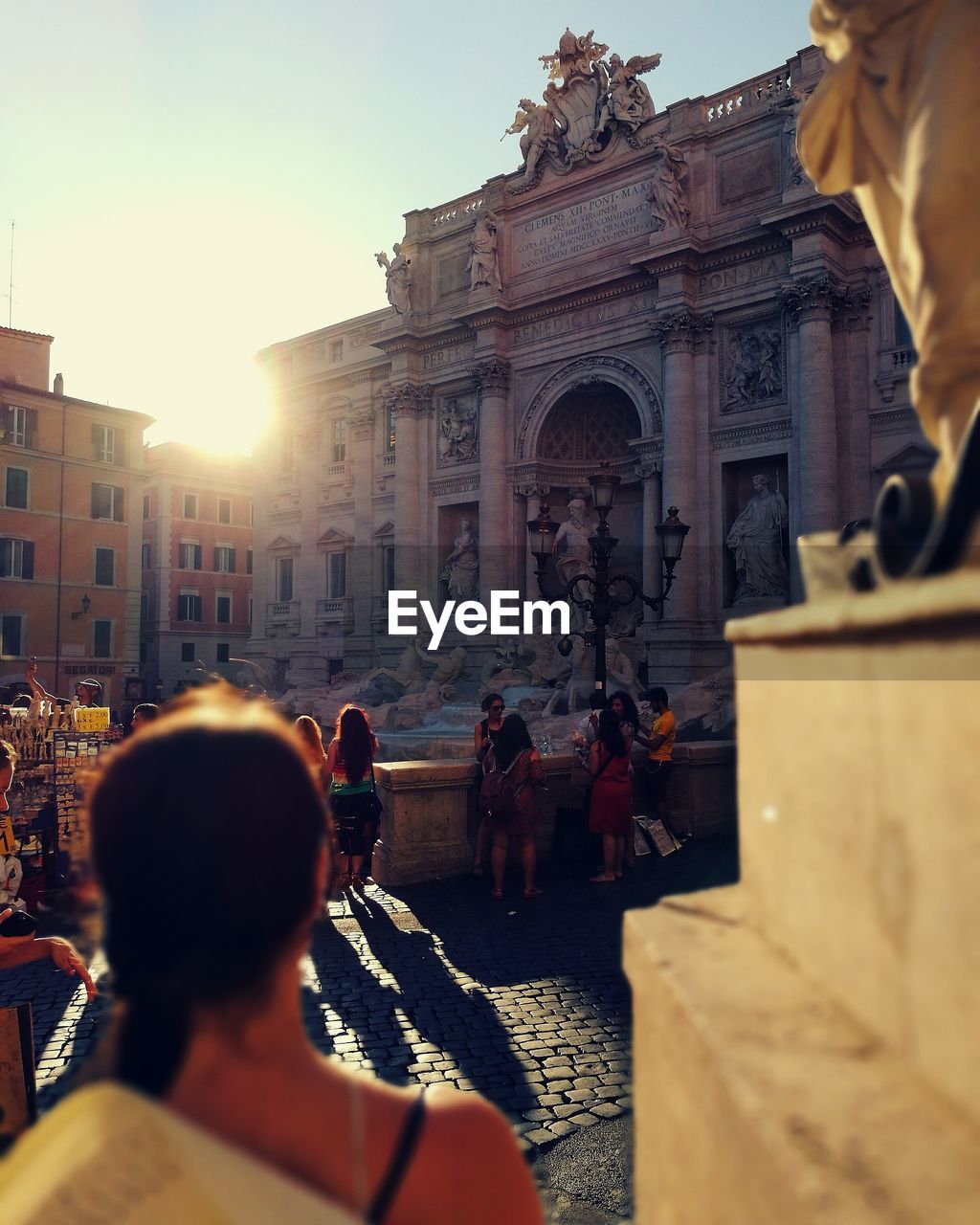 People at trevi fountain in city