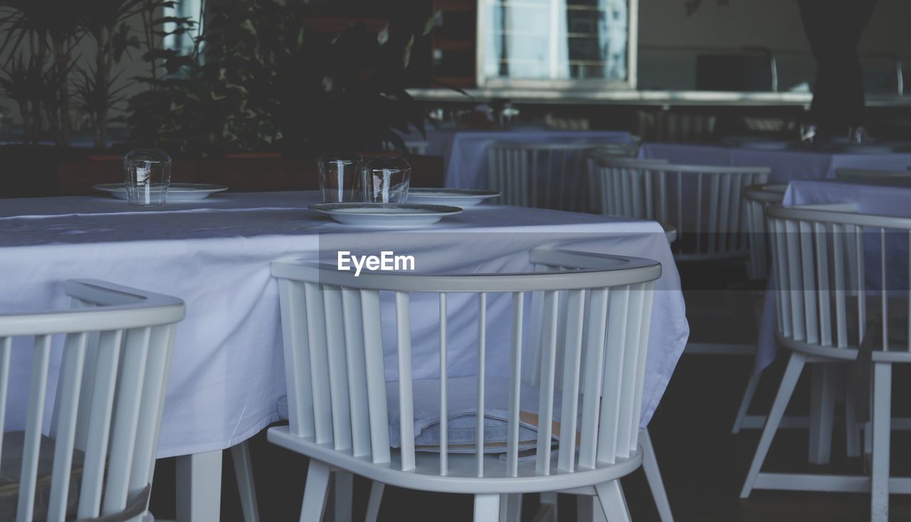 Empty chairs and tables in restaurant