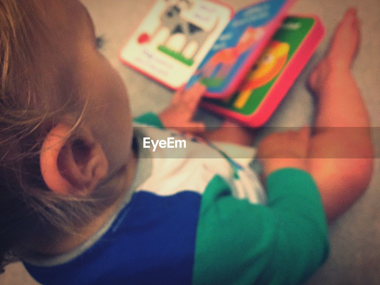 High angle view of baby with book