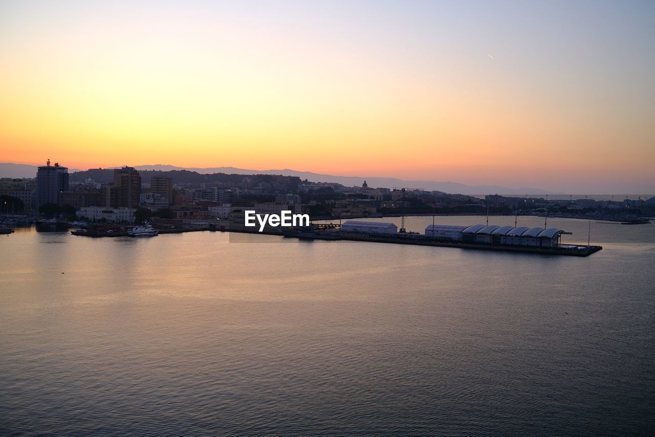 water, architecture, sky, dawn, sunset, horizon, built structure, city, reflection, building exterior, nature, sea, travel destinations, transportation, evening, building, nautical vessel, no people, cityscape, beauty in nature, scenics - nature, landscape, travel, outdoors, urban skyline, twilight, tranquility, bay, ship, mode of transportation, waterfront, tourism, harbor, coast