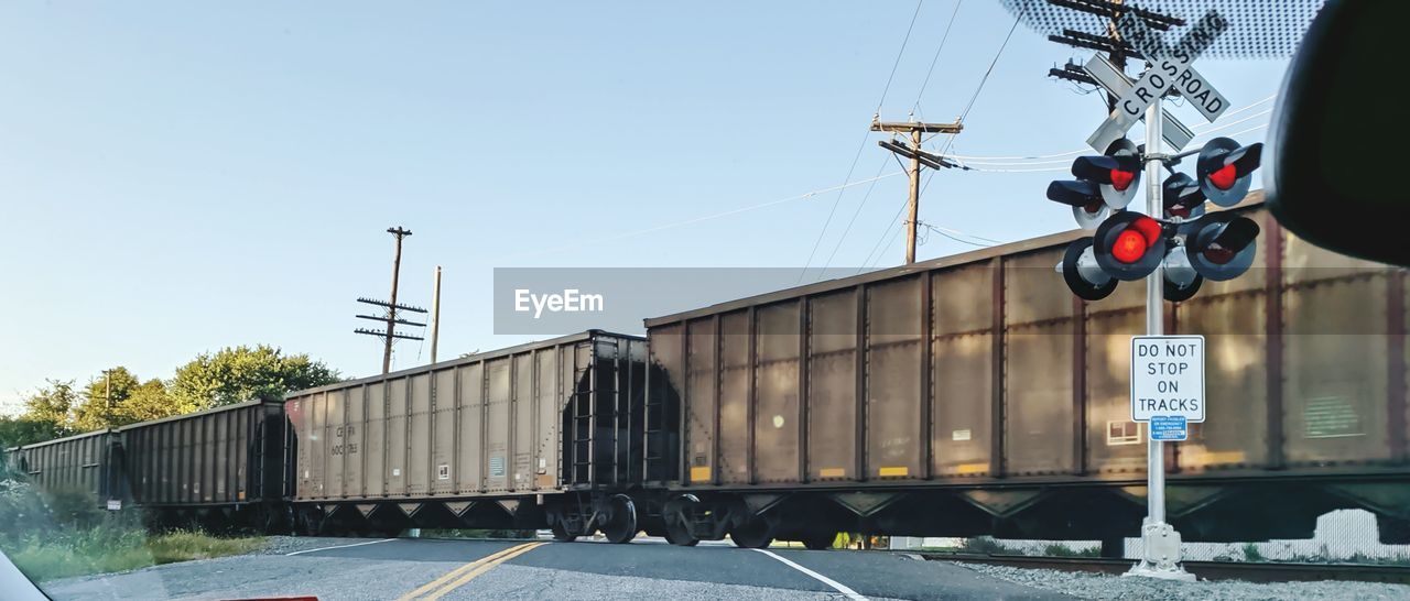 Train on railroad track against clear sky