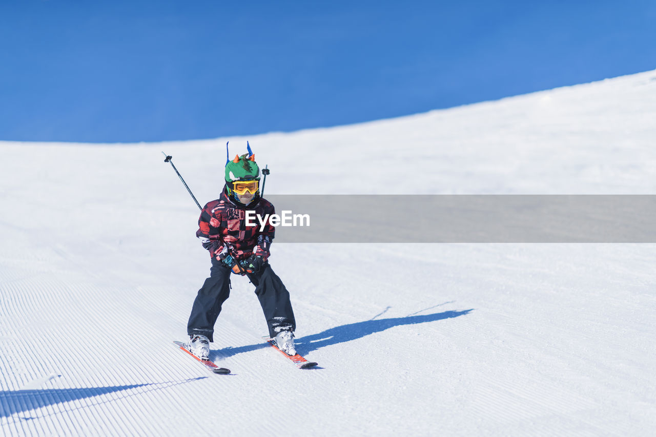 Boy skiing on snowcapped mountain