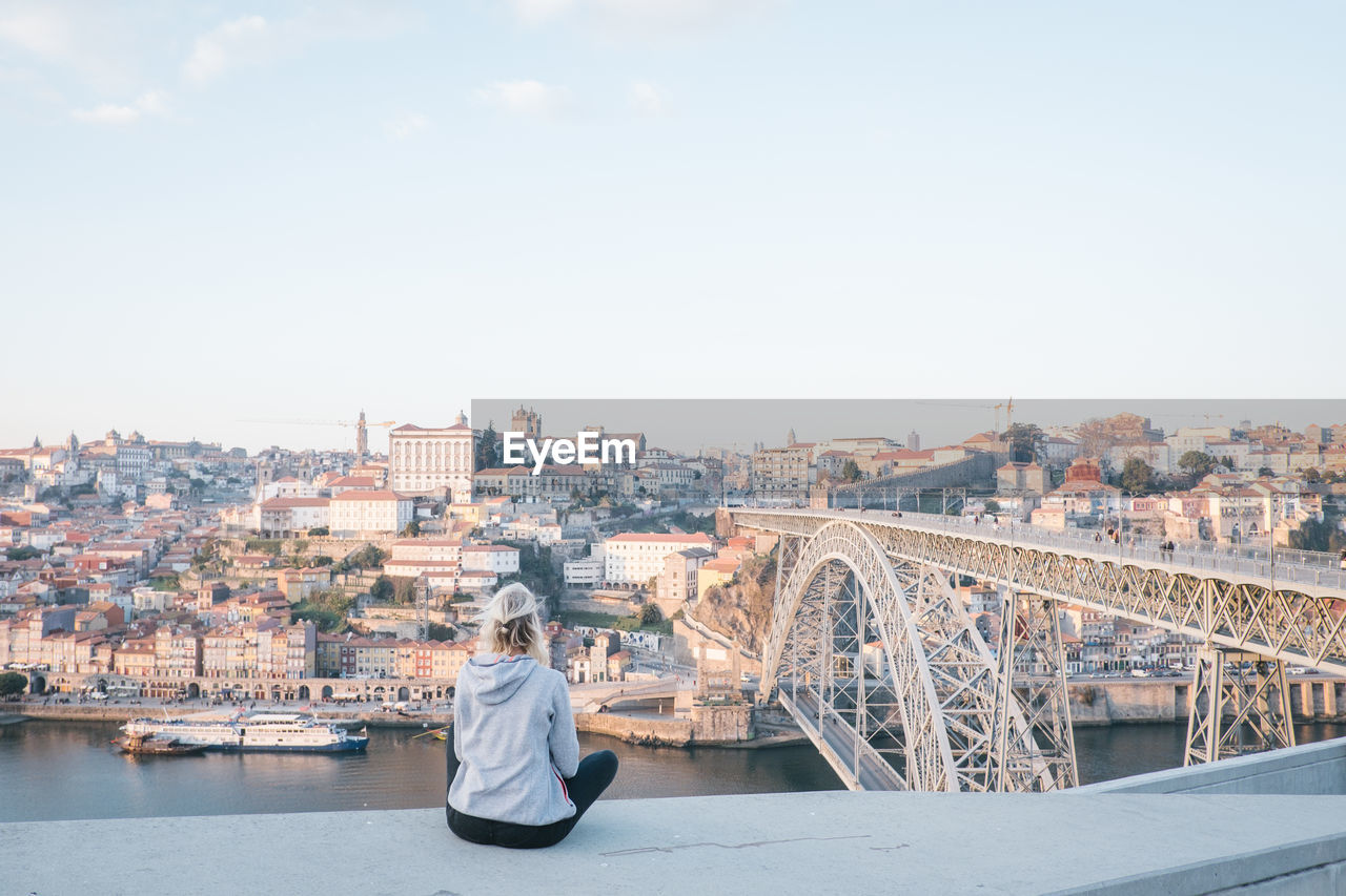 Rear view of woman looking at cityscape