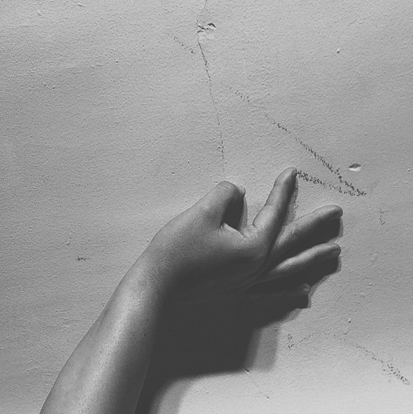 Cropped image of hand on wall