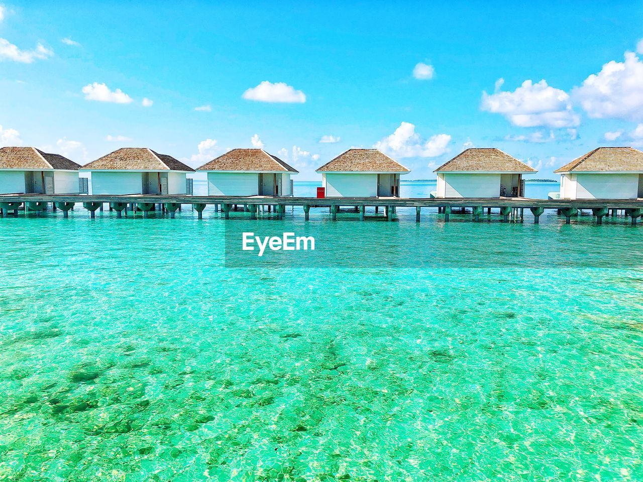 Villas at blue sea of maldives against sky