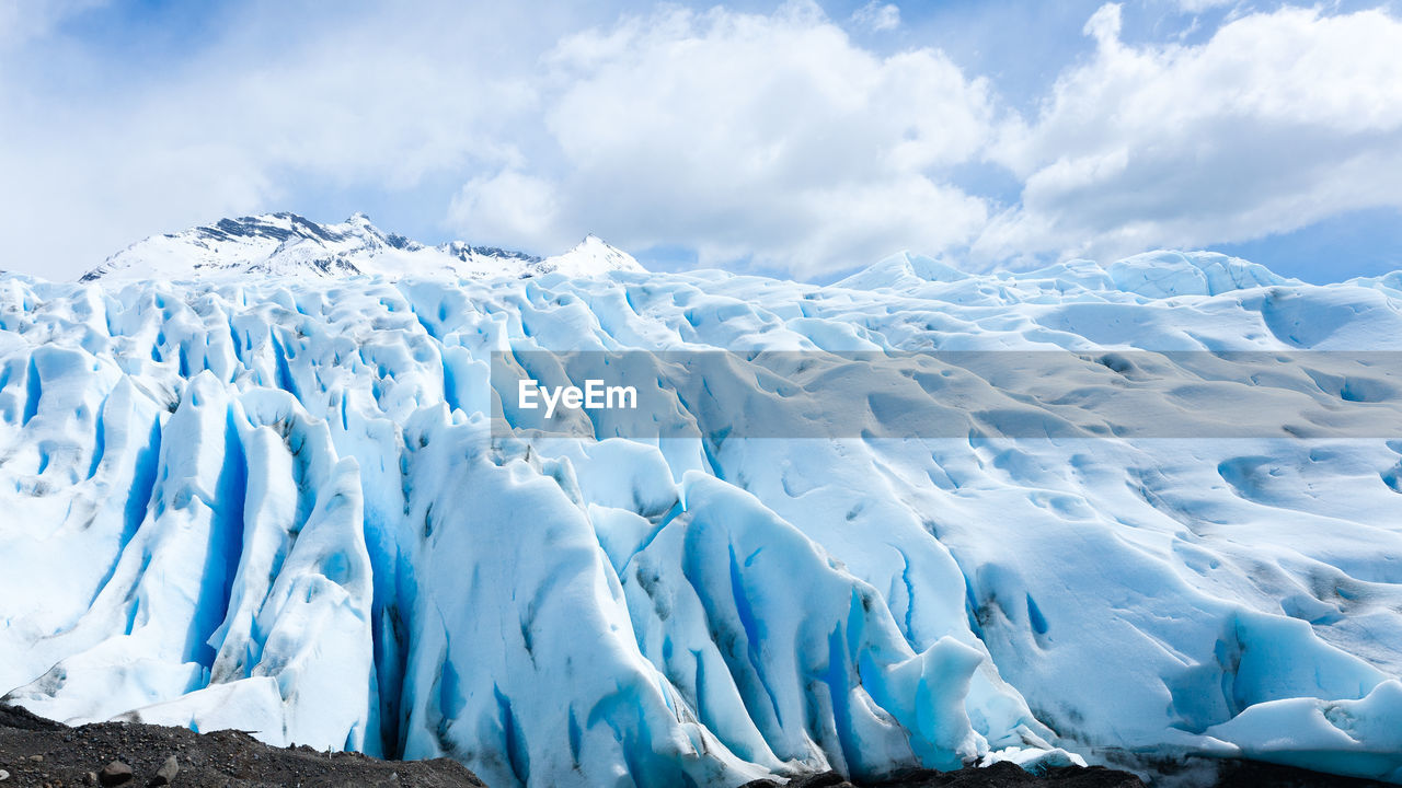 low angle view of snow covered mountain against sky