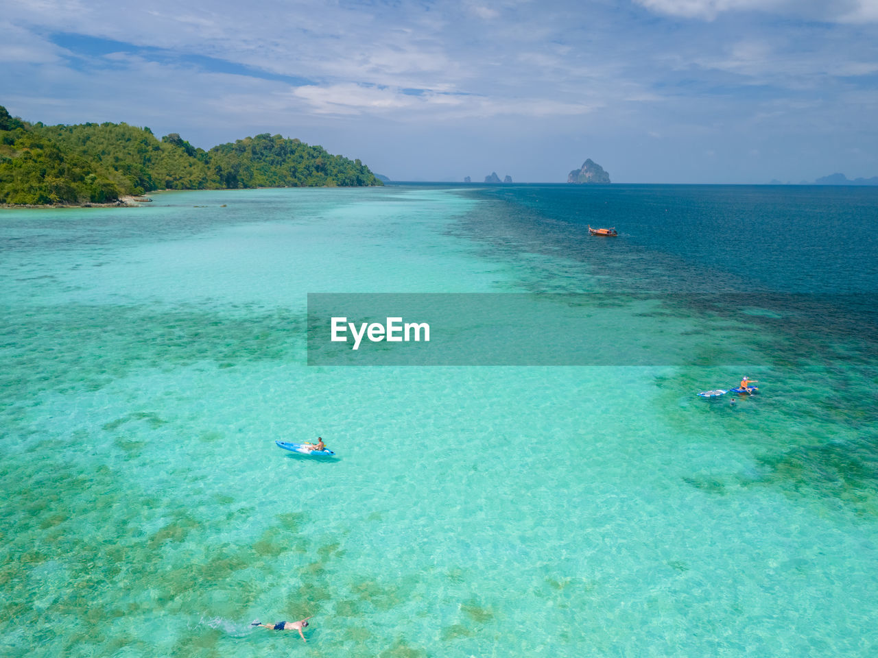 high angle view of people swimming in sea against sky