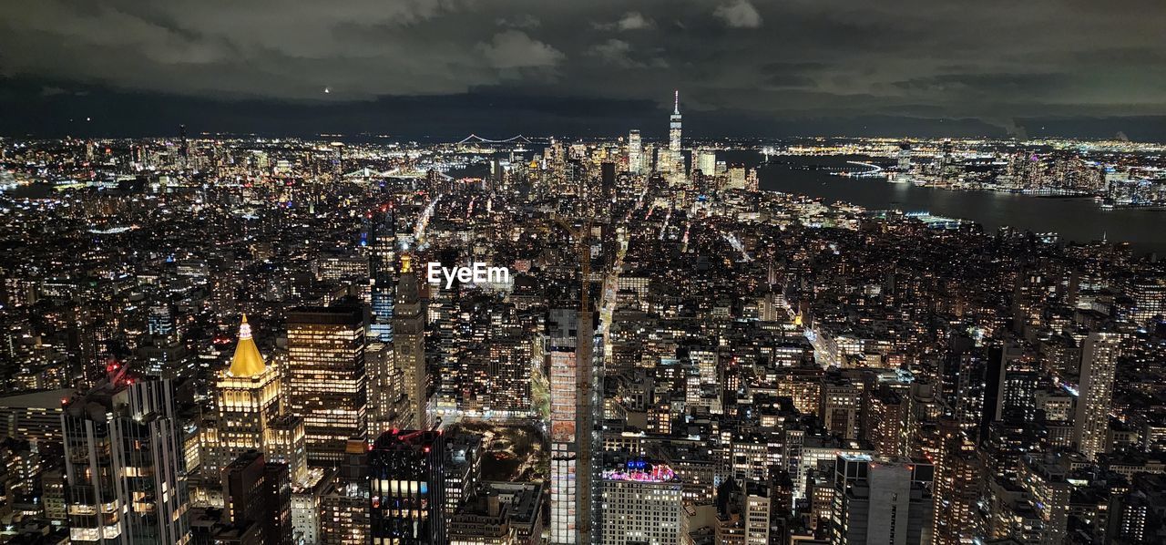 architecture, city, cityscape, building exterior, built structure, metropolis, building, urban area, skyline, metropolitan area, sky, night, skyscraper, aerial photography, illuminated, office building exterior, landscape, travel destinations, urban skyline, nature, crowd, cloud, aerial view, residential district, city life, downtown, crowded, high angle view, outdoors, evening, travel, business finance and industry, water, bird's-eye view, downtown district, transportation, tourism, tower, street, horizon