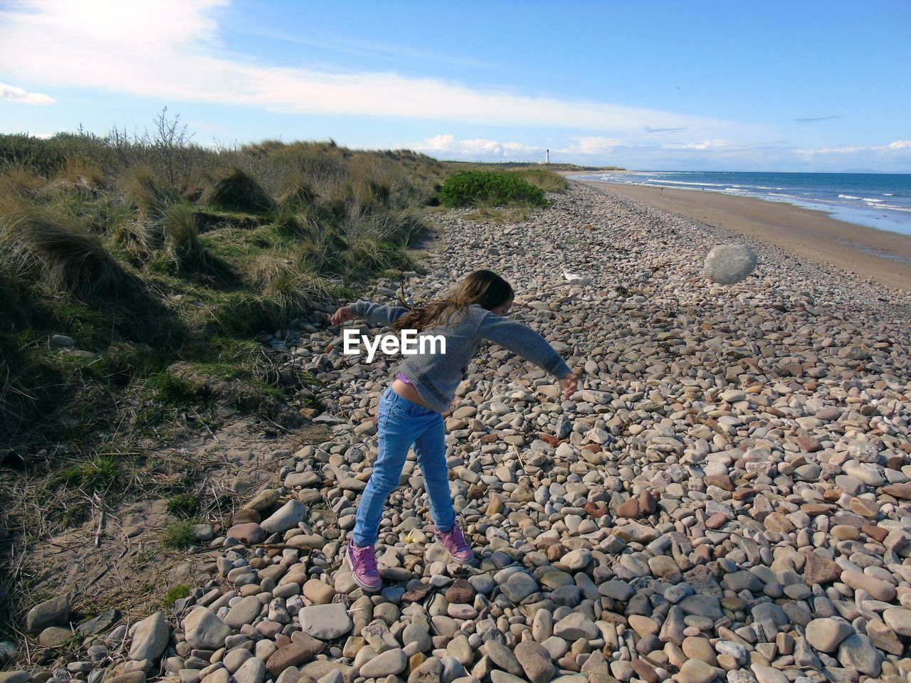 MAN ON BEACH AGAINST SKY