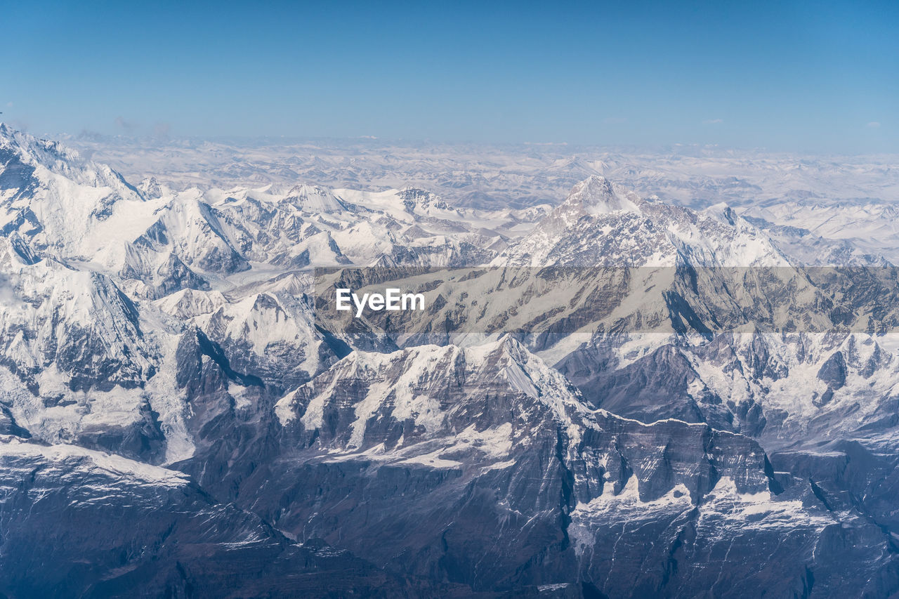 AERIAL VIEW OF SNOW COVERED LANDSCAPE