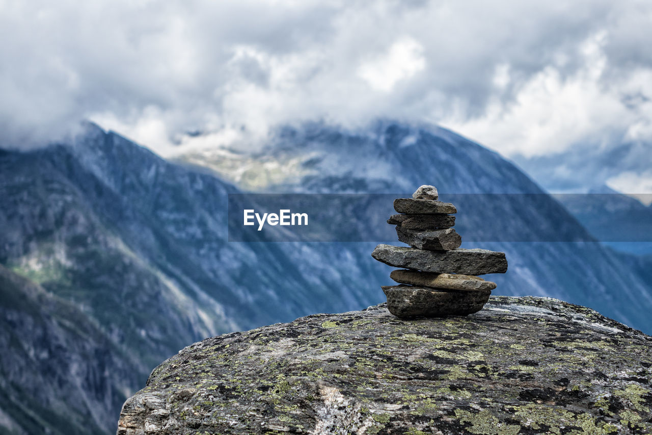 Stack of rocks on mountain against sky