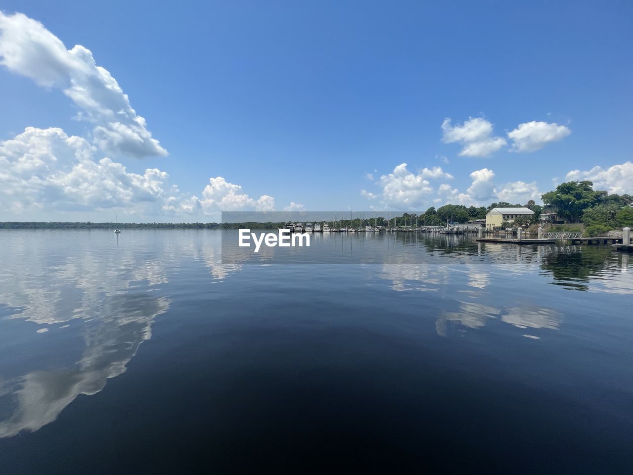 reflection, sky, water, cloud, nature, horizon, blue, sunlight, scenics - nature, beauty in nature, lake, environment, tranquility, no people, landscape, tranquil scene, morning, outdoors, architecture, tree, built structure, dusk, idyllic, building, travel destinations, day, building exterior