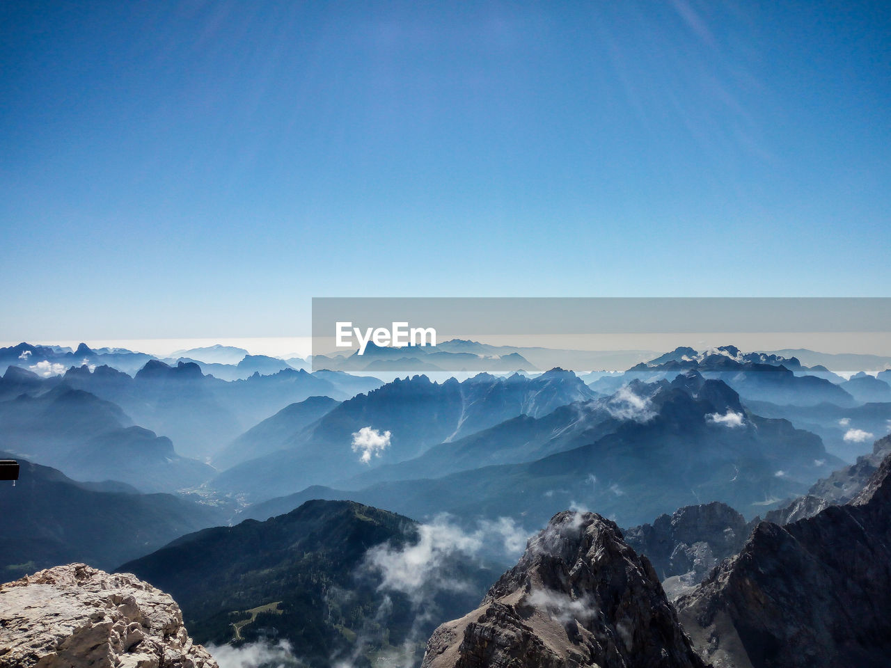 Scenic view of silhouette mountains against blue sky