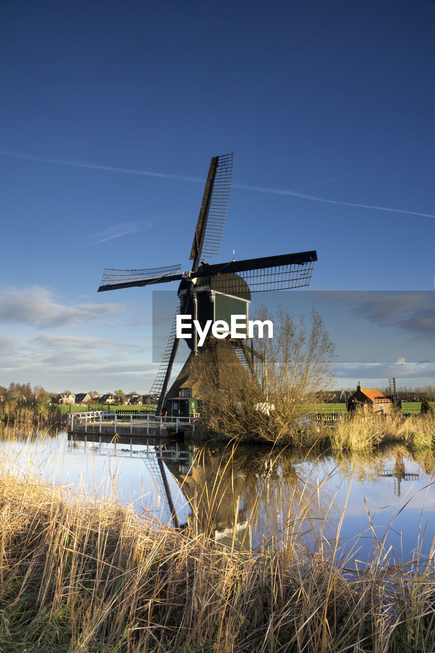 WINDMILL ON FIELD AGAINST SKY