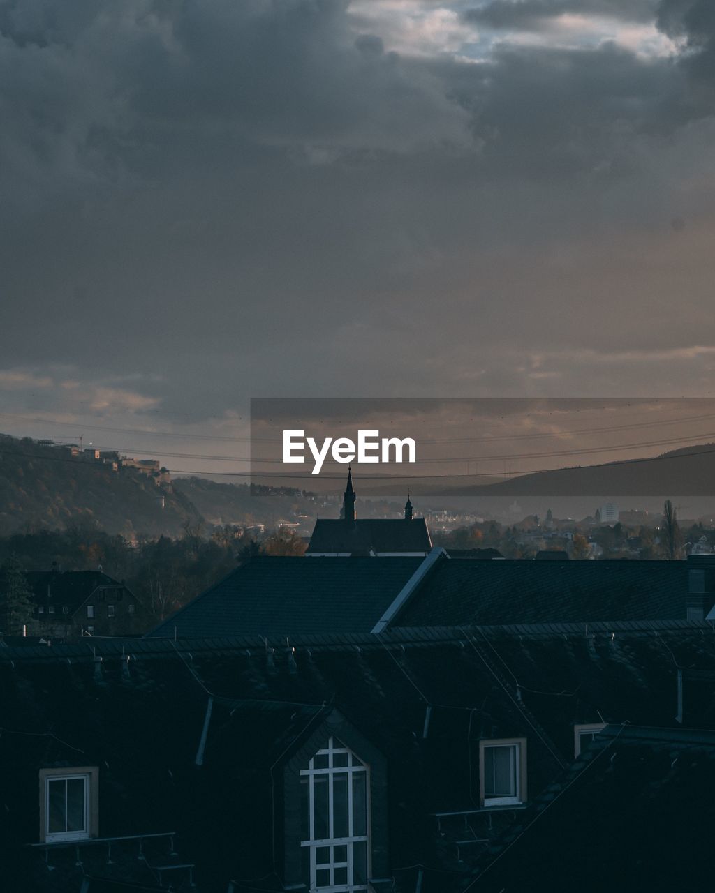 High angle view of buildings against cloudy sky at dusk