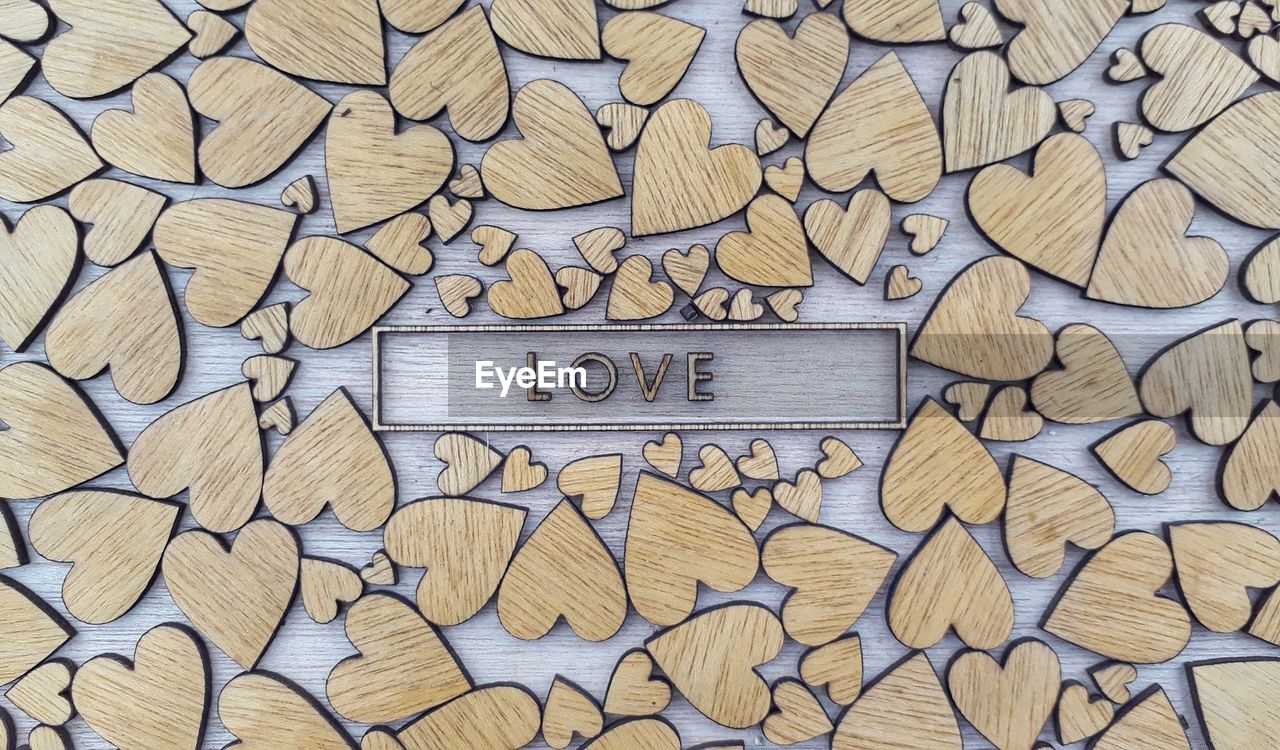 Directly above shot of text surrounded with heart shaped wood