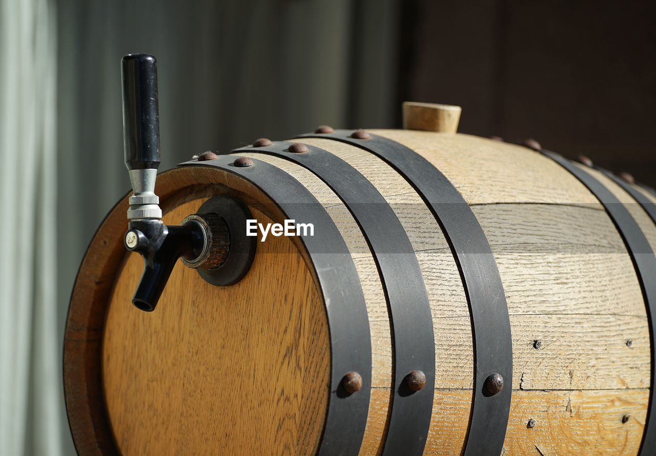 Wooden barrel with handle filled with alcohol