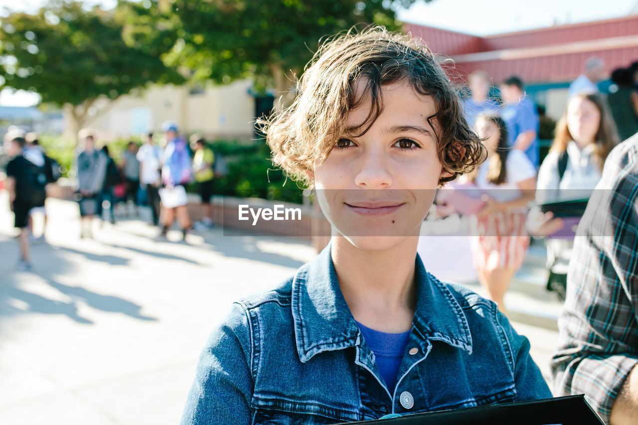 Portrait of a girl with short hair at her first day of school