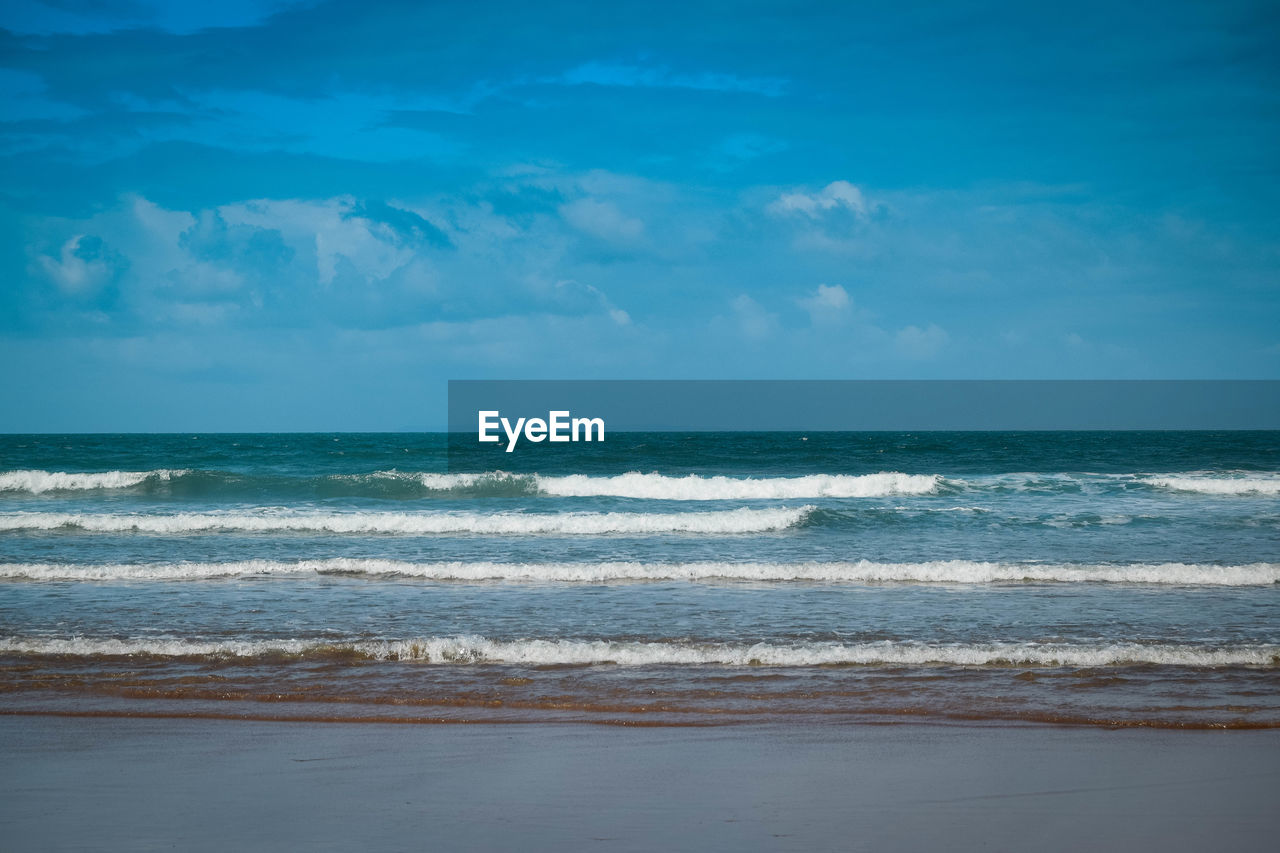 Scenic view of sea against blue sky