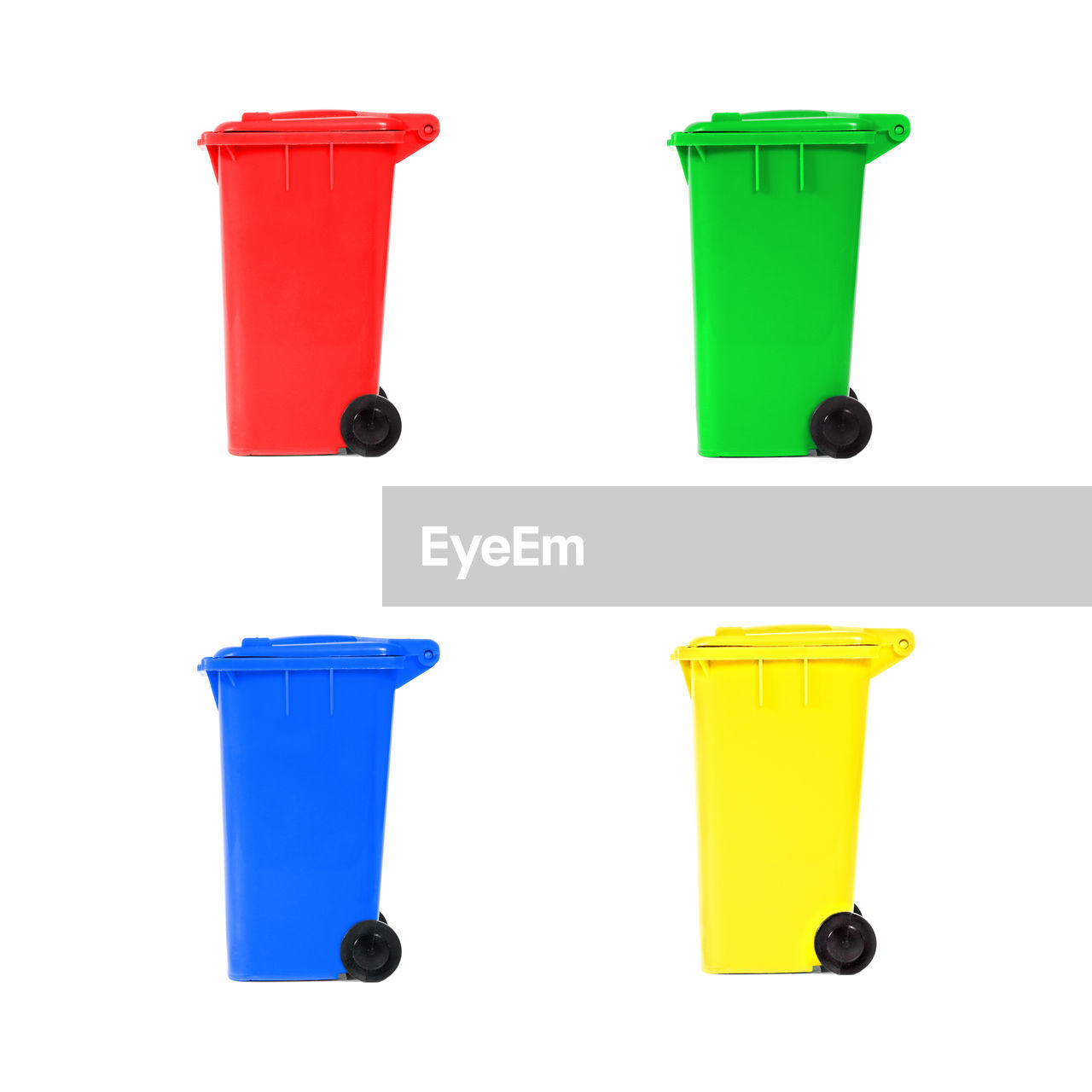 Close-up of multi colored garbage bin over white background