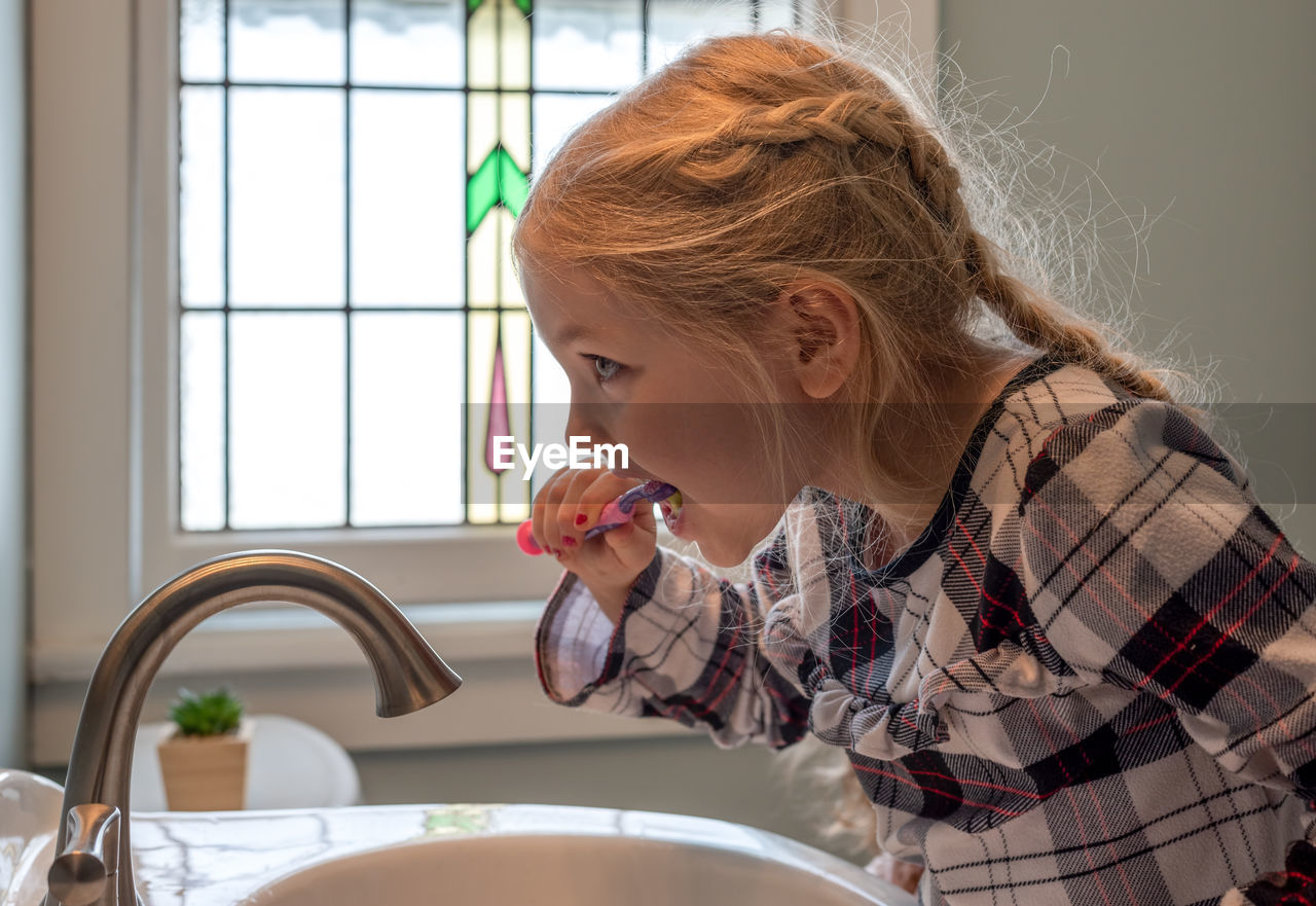 Side view of young woman at home