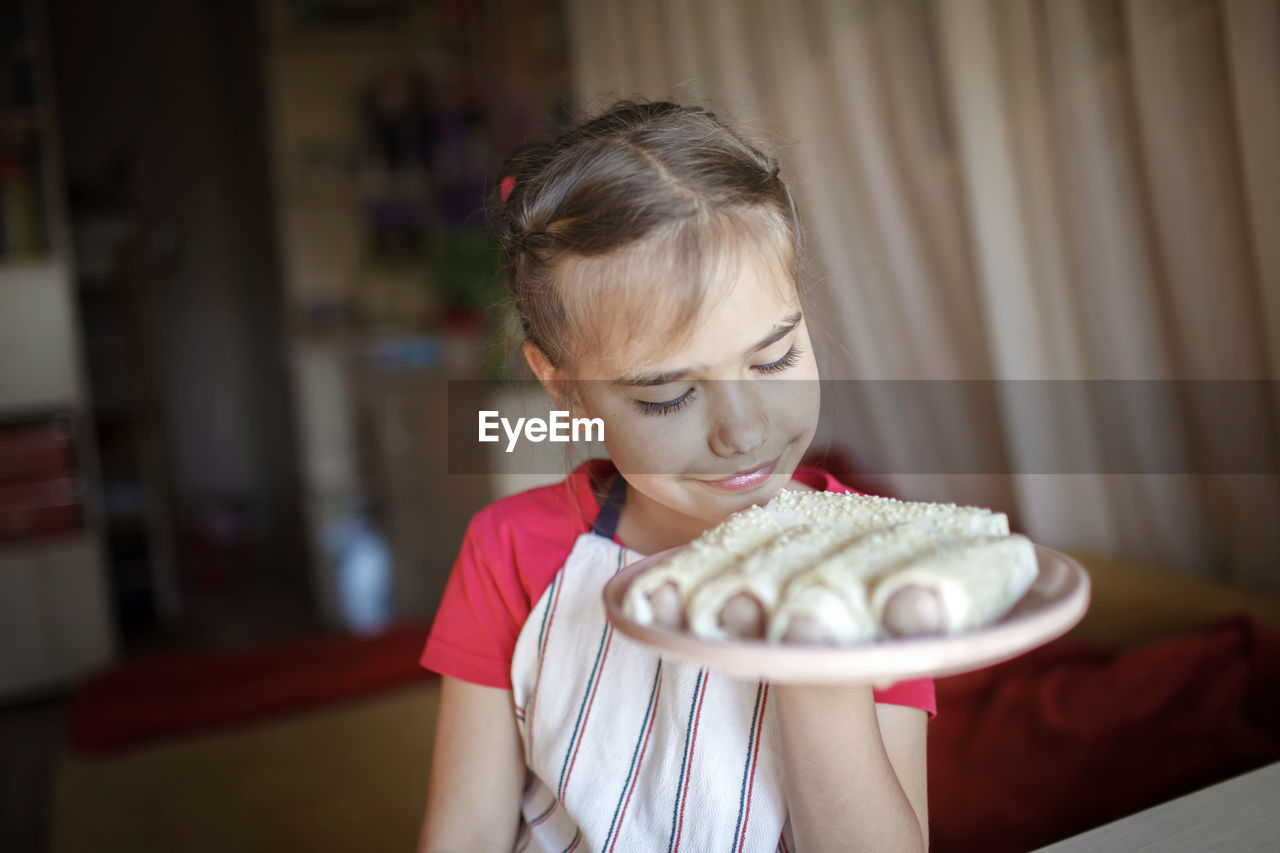 Girl holding ice cream at home