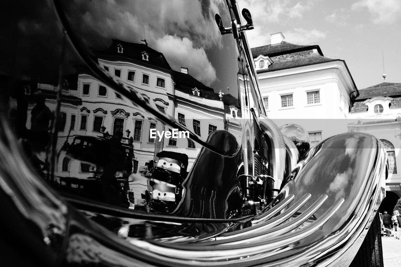 Reflection of buildings on car in city