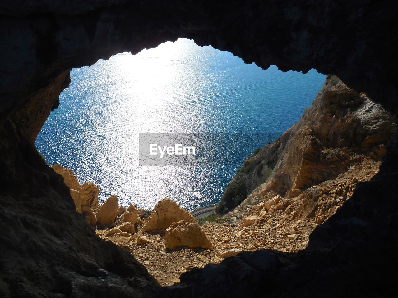 Scenic view of sea seen through cave