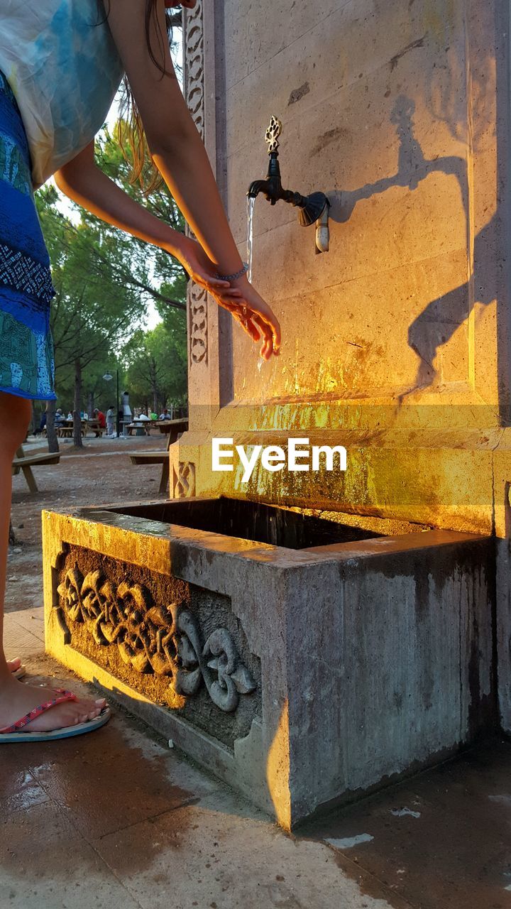 LOW SECTION OF MAN WORKING AT DUSK