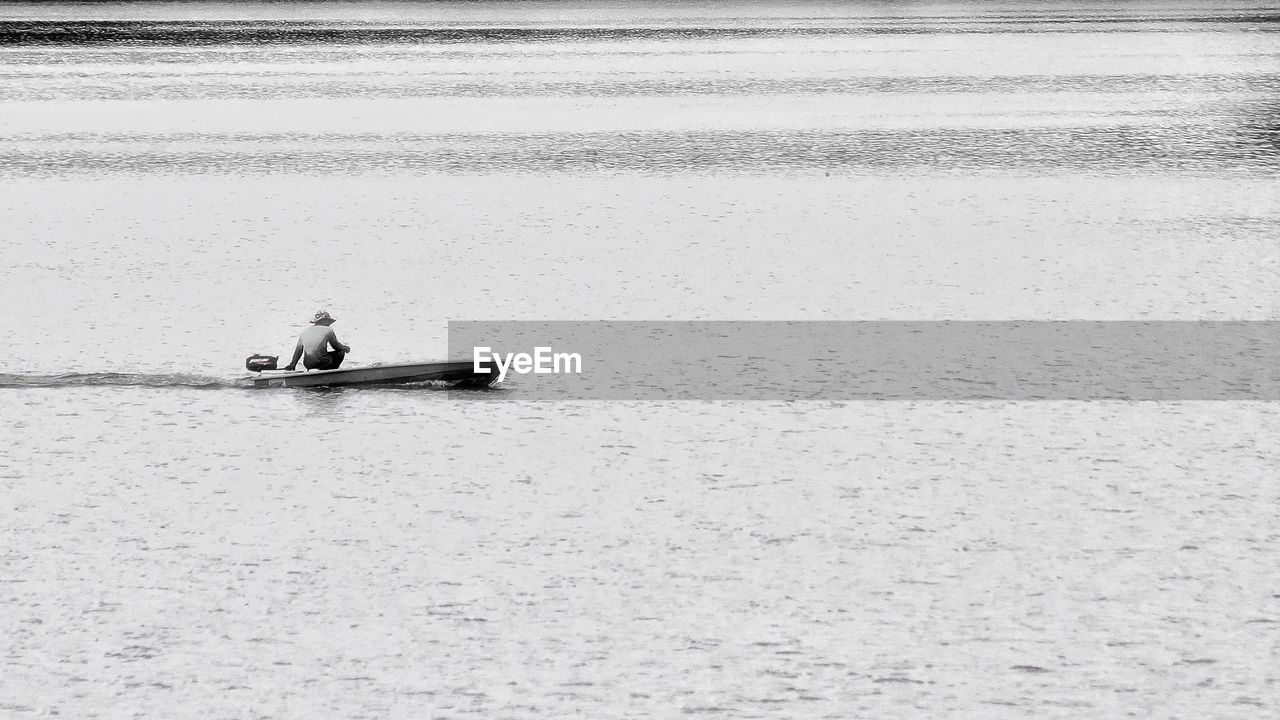 PEOPLE ON BOAT AT SEA