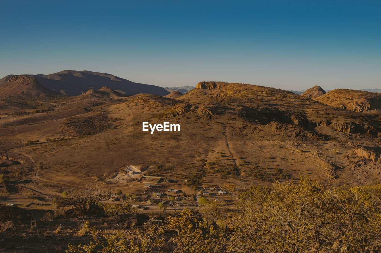 Scenic view of mountains against clear blue sky