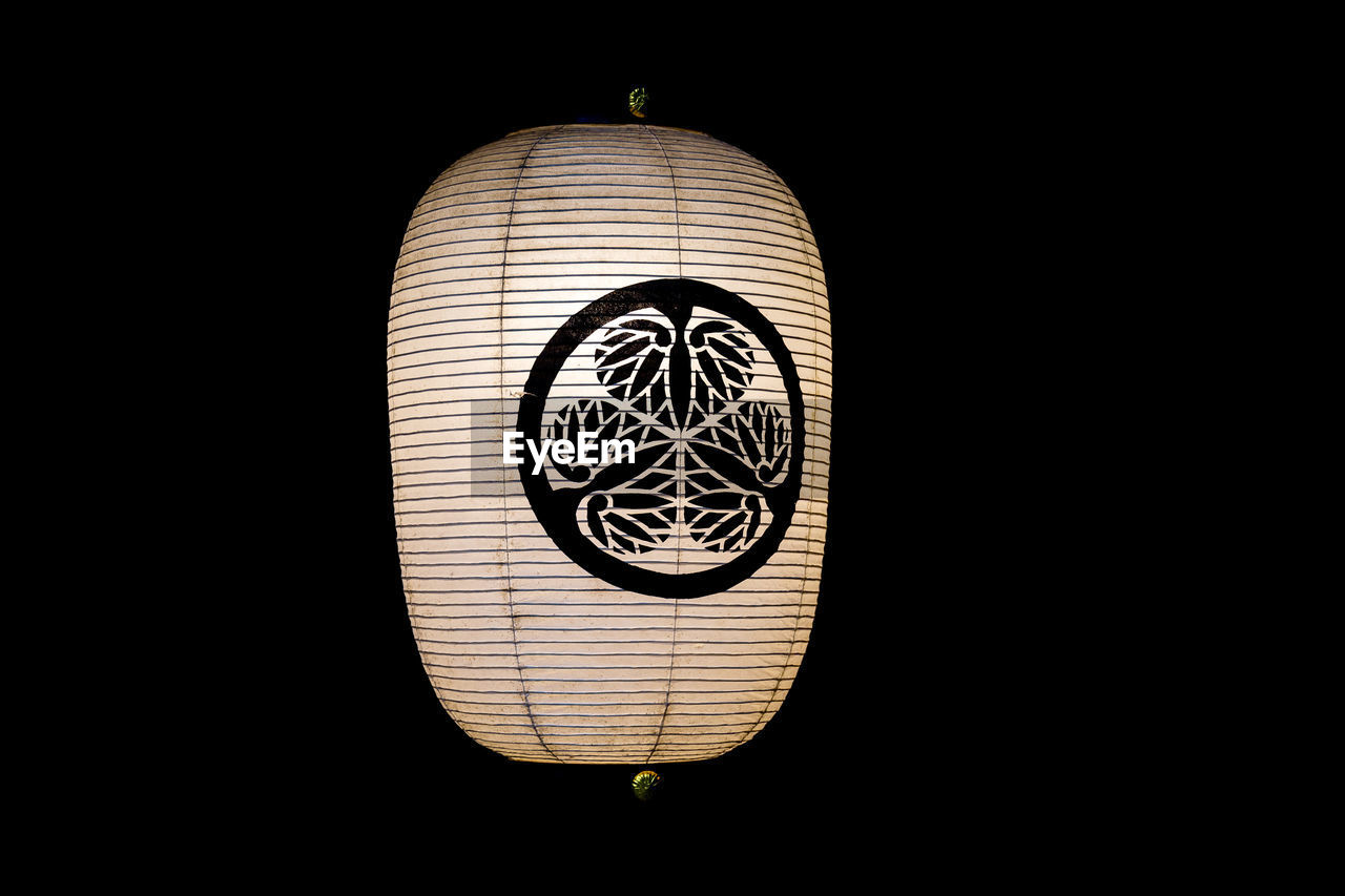 Close-up of illuminated lantern against black background