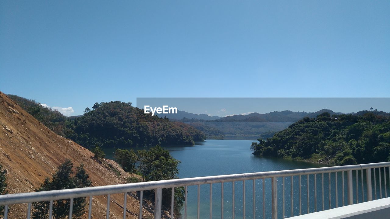 Scenic view of mountains against clear blue sky