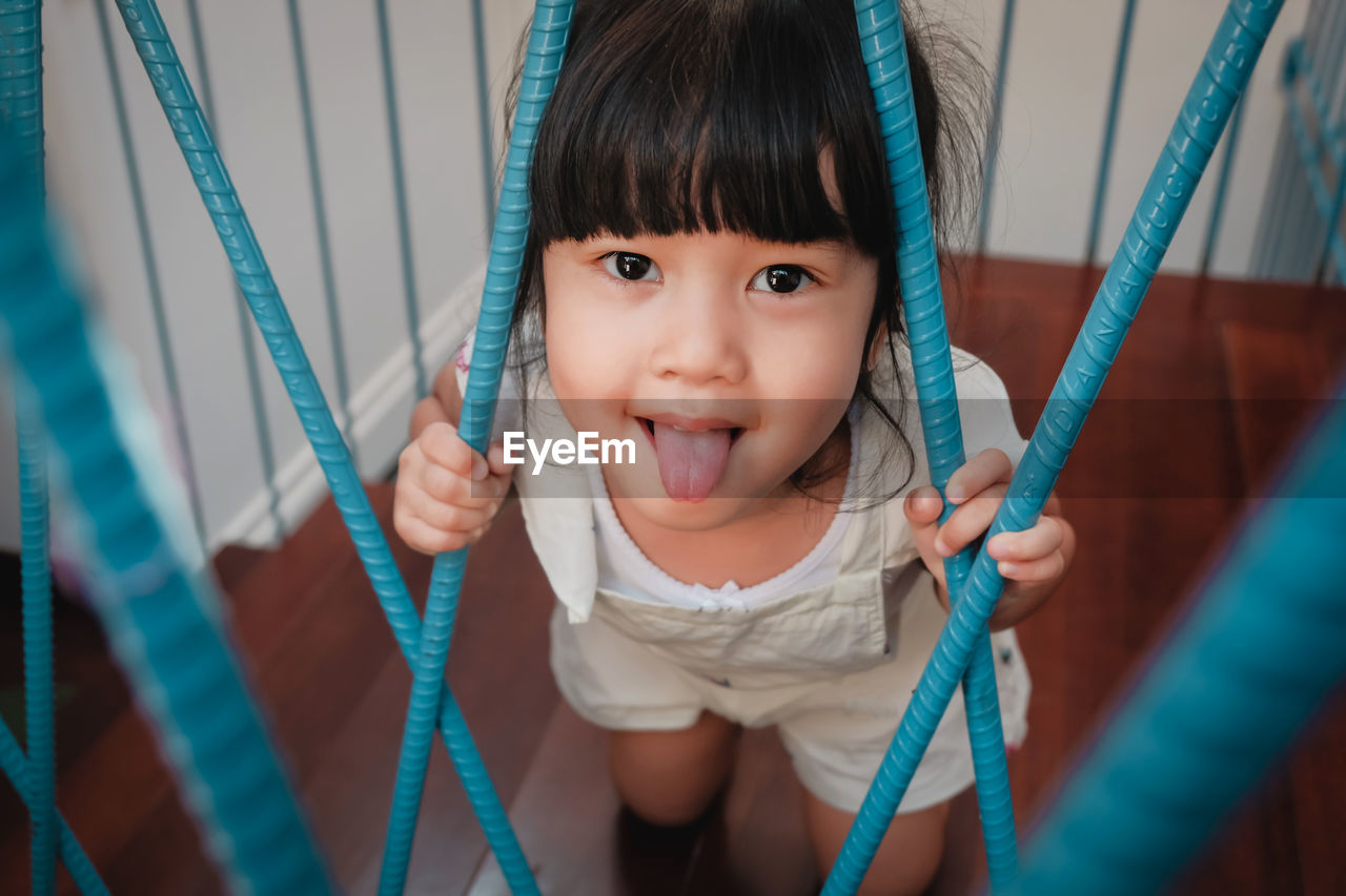 Portrait of cute girl sticking out tongue